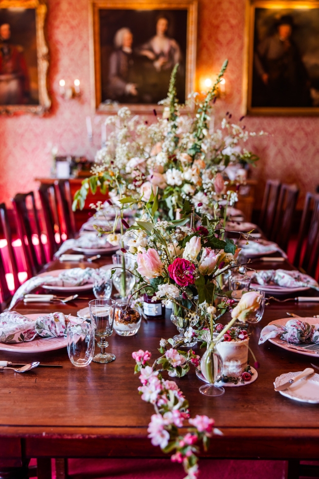 Beautiful floral runner wedding breakfast table layout by Salt & Scent